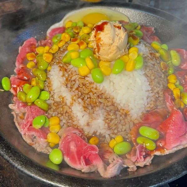 Sizzling Tasty Pot! Taiwanese hot pot with beef, rice, corn, edamame, and a fried egg.