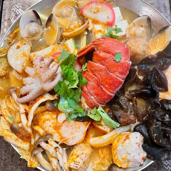 Tasty Pot! Taiwanese hot pot with lobster, octopus, clams, mushrooms, and tofu in a rich broth.