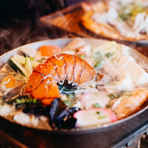 Steaming Tasty Pot! Taiwanese hot pot with lobster, vegetables, and fish cakes.