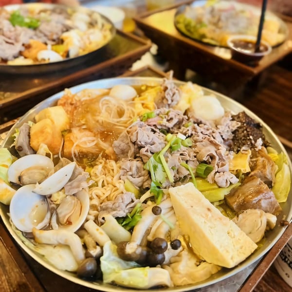A close-up of a Taiwanese hot pot with various ingredients like meat, seafood, and vegetables.